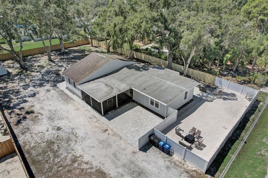 3030 Ashton Road Sarasota, FL 34231 - Photo 32 of 41 a view of a backyard with chairs and a stove