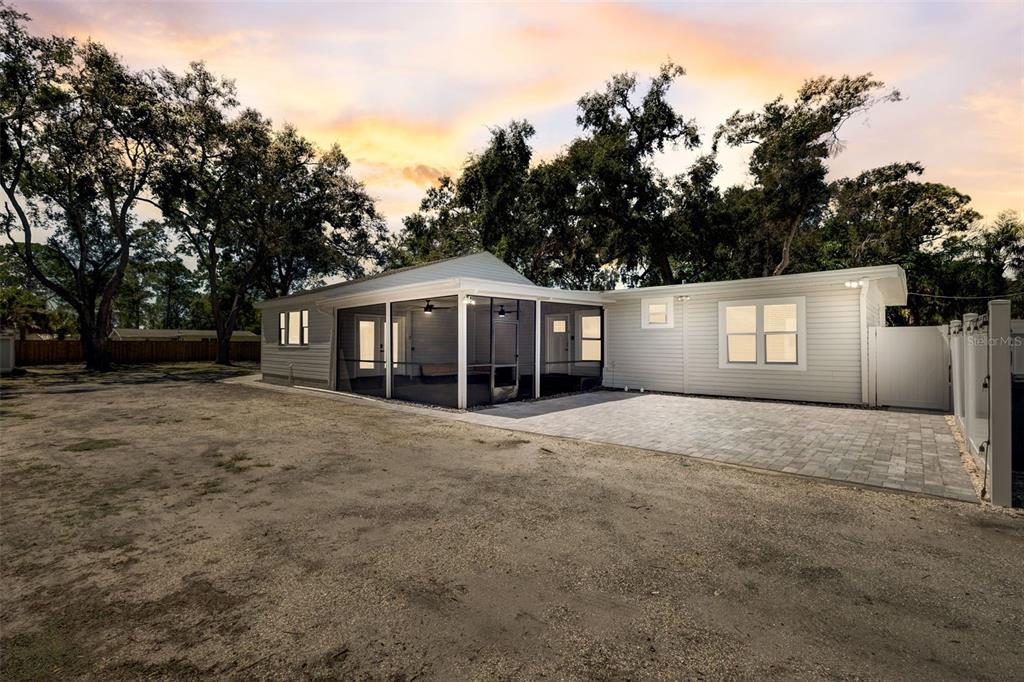 3030 Ashton Road Sarasota, FL 34231 - Photo 36 of 41 a front view of a house with a yard and garage