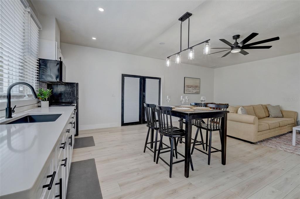 3030 Ashton Road Sarasota, FL 34231 - Photo 6 of 41 a view of a dining room with furniture and wooden floor
