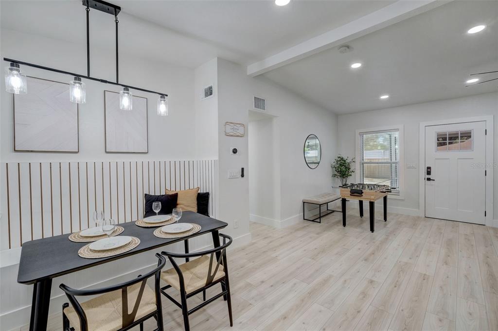 3030 Ashton Road Sarasota, FL 34231 - Photo 9 of 41 a view of a dining room with furniture and wooden floor