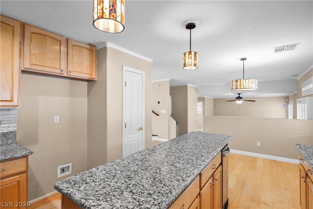 708 Vortex Avenue Henderson, NV 89002 - Photo 15 of 71 A well-appointed kitchen island with stone counters provides ample space for culinary endeavors.