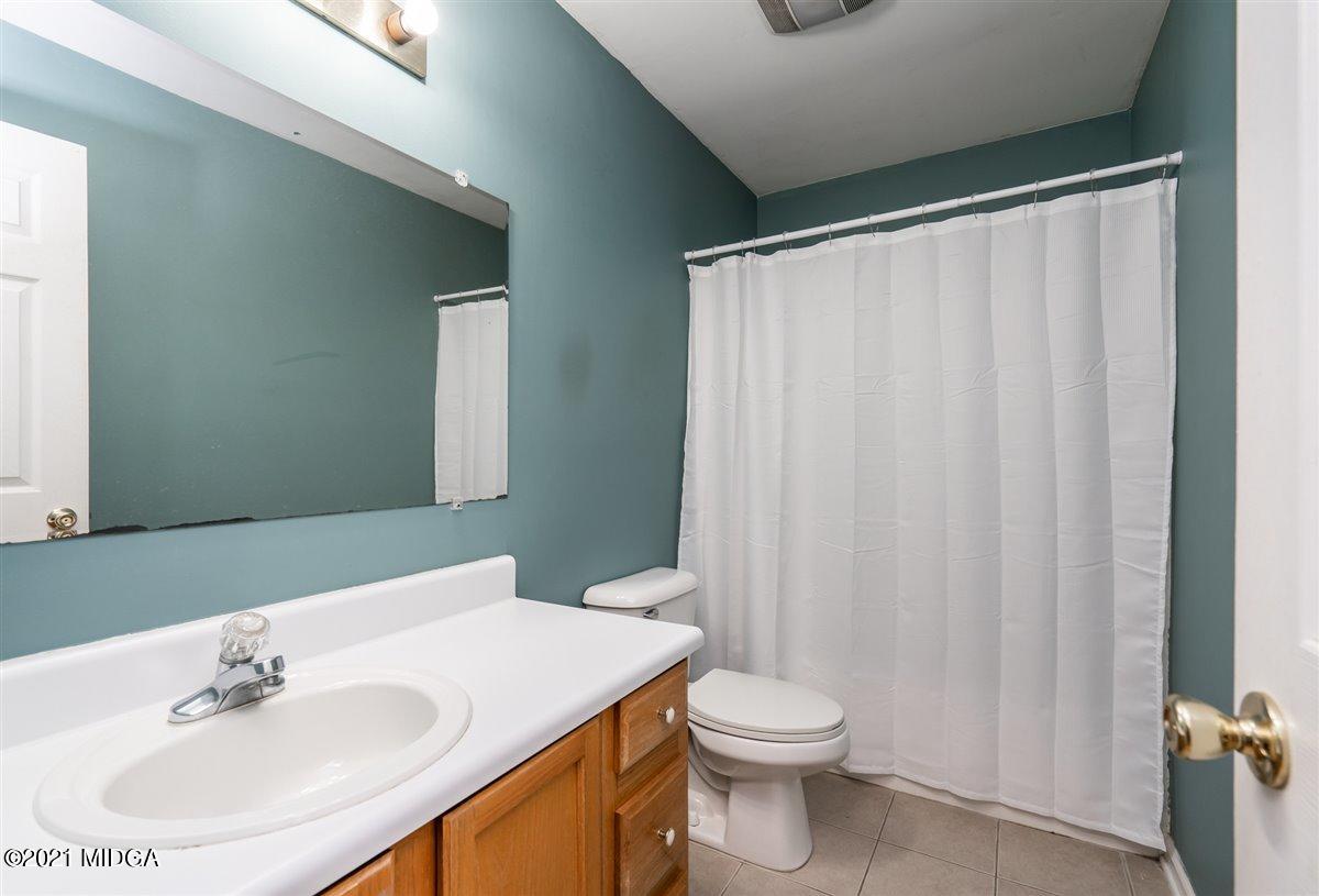 306 Jason Court Macon, GA 31216 - Photo 16 of 22 a bathroom with a sink a toilet and shower curtain