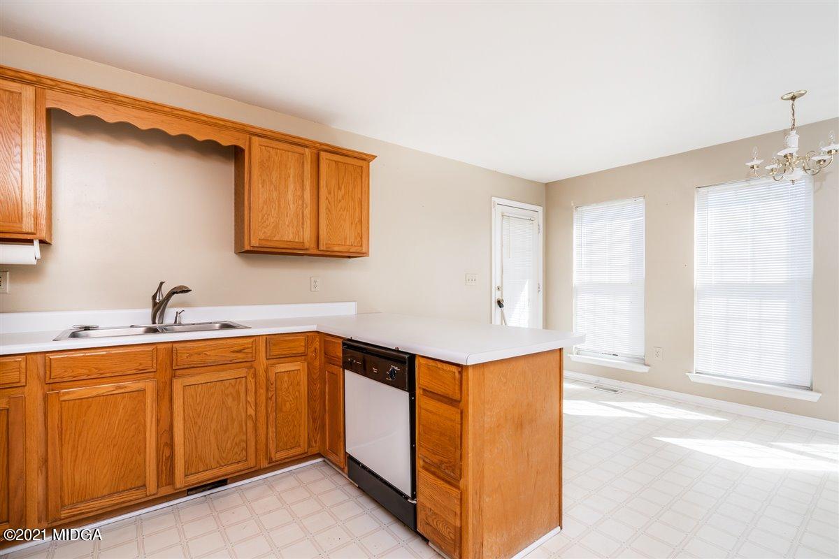 306 Jason Court Macon, GA 31216 - Photo 18 of 22 a kitchen with a sink a window and cabinets