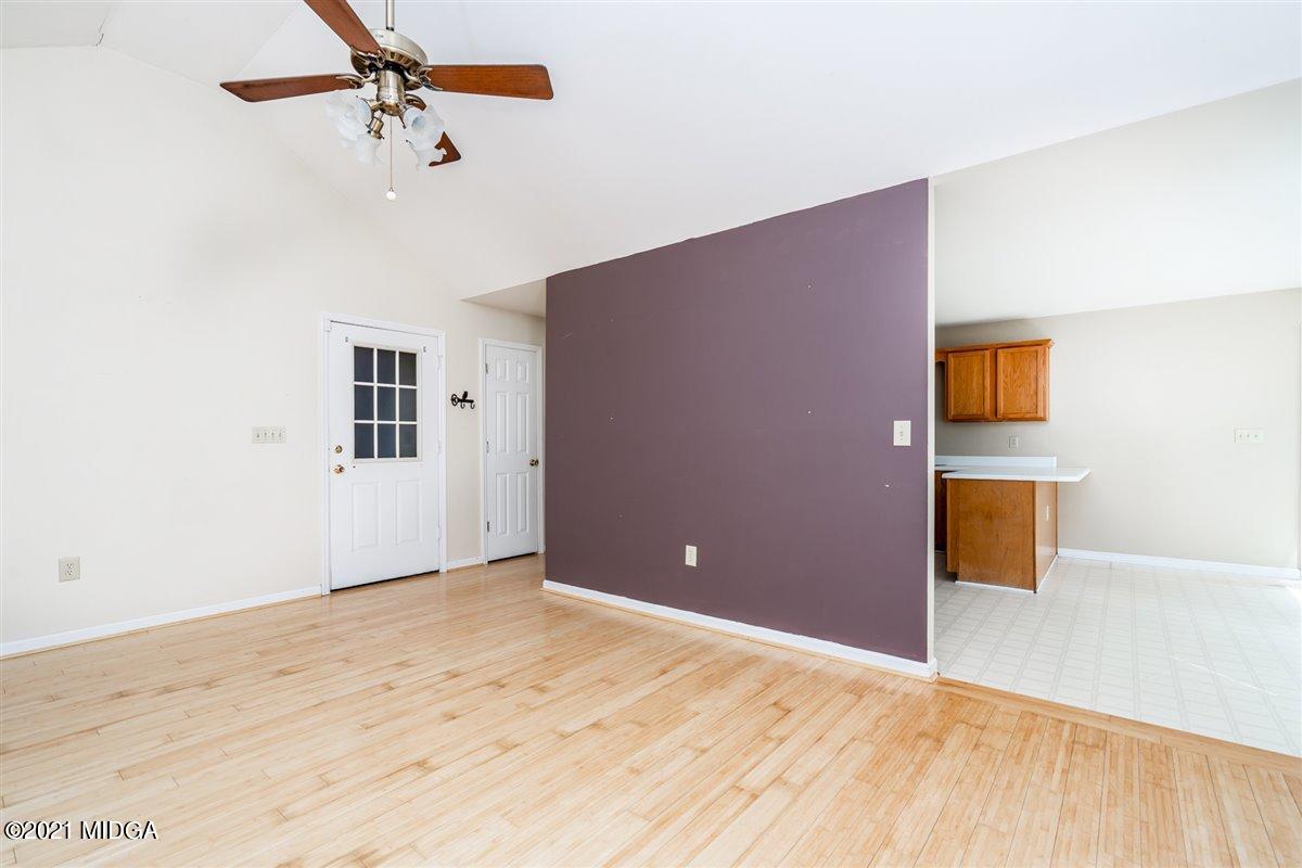 306 Jason Court Macon, GA 31216 - Photo 21 of 22 a view of a livingroom with wooden floor and a ceiling fan