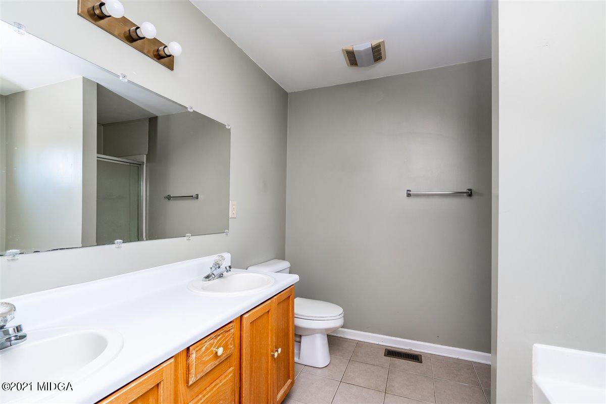 306 Jason Court Macon, GA 31216 - Photo 10 of 22 a bathroom with a sink a toilet and a mirror