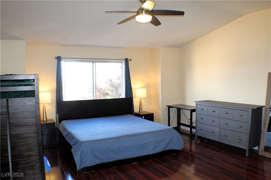 2344 Kenneth Avenue Henderson, NV 89052 - Photo 21 of 25 SPACIOUS PRIMARY BEDROOM WITH LIGHT FIXTURE / CEILING FAN, VAULTED CEILING & WOOD LAMINATE FLOORING!