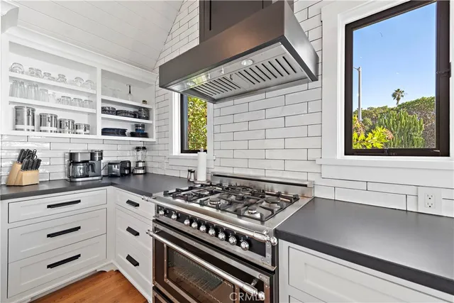 a kitchen with stainless steel appliances a stove and a cabinets