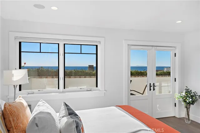 a bedroom with a bed and a potted plant