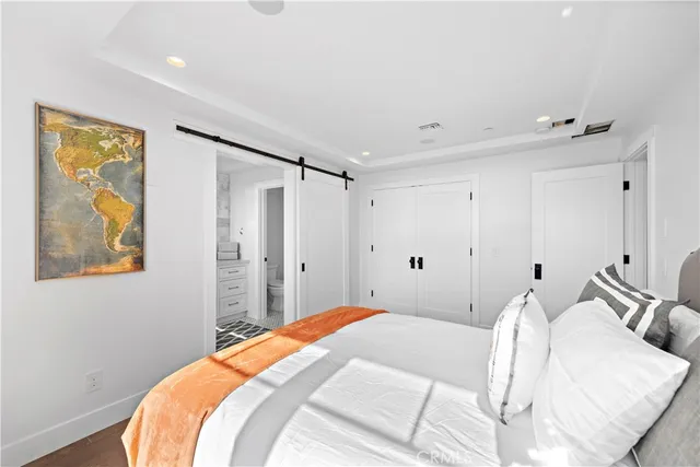 a bathroom with a double vanity sink a mirror and a bathtub