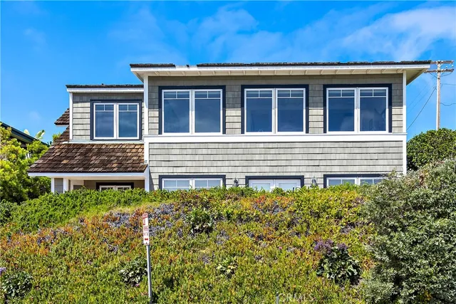 an aerial view of a houses with a ocean view