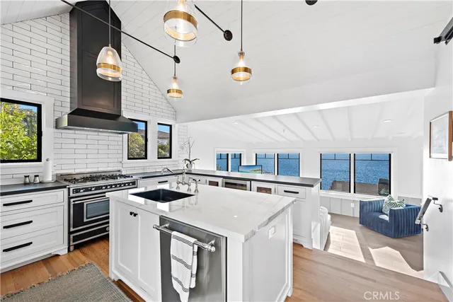 a kitchen with stainless steel appliances granite countertop a stove and a sink