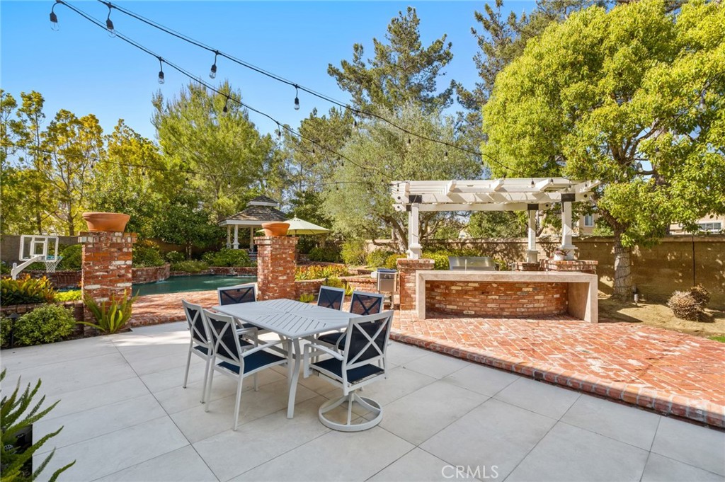 3 Bridgeport Road Newport Coast, CA 92657 - Photo 17 of 25 a view of a patio with table and chairs and potted plants