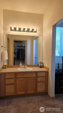 a spacious bathroom with a double vanity sink and a mirror