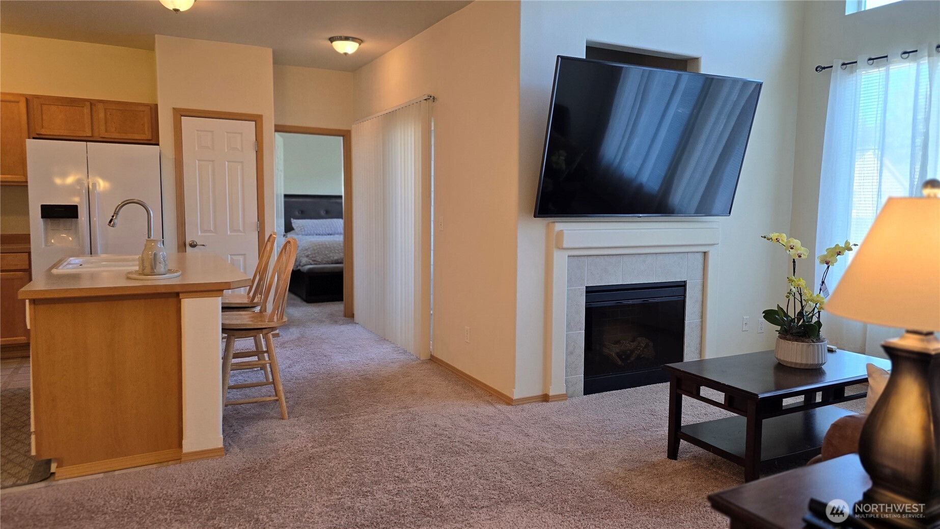 1373 Hudson Street DuPont, WA 98327 - Photo 5 of 12 a living room with furniture a fireplace and a flat screen tv