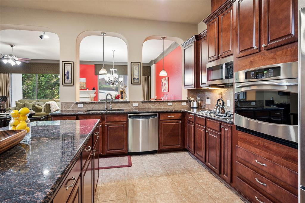 835 Rockingham Drive Irving, TX 75063 - Photo 5 of 27 a kitchen with stainless steel appliances granite countertop a stove and a sink