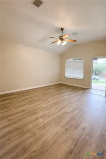a kitchen with granite countertop a stove a microwave and a sink