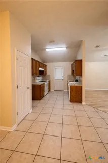 a view of an empty room and a bathroom