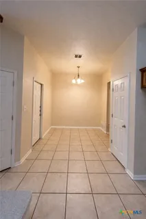 a view of a utility room with cabinet and door