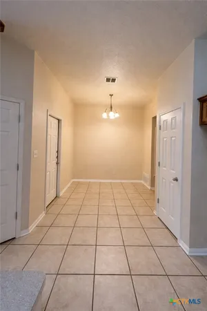 a view of a utility room with cabinet and door