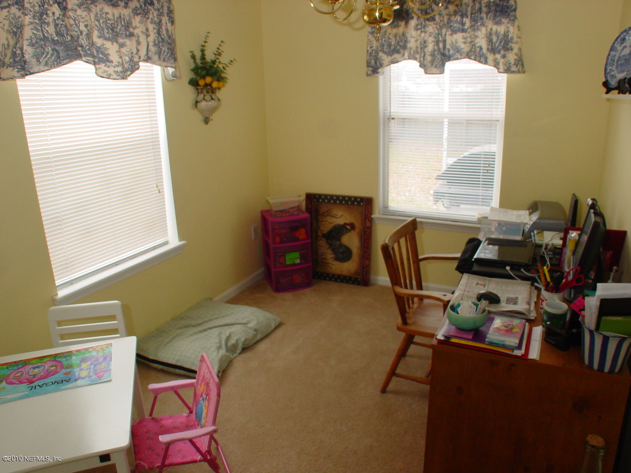 8774 E Spring Jacksonville, FL 32244 - Photo 7 of 8 a view of a workspace with furniture and a window