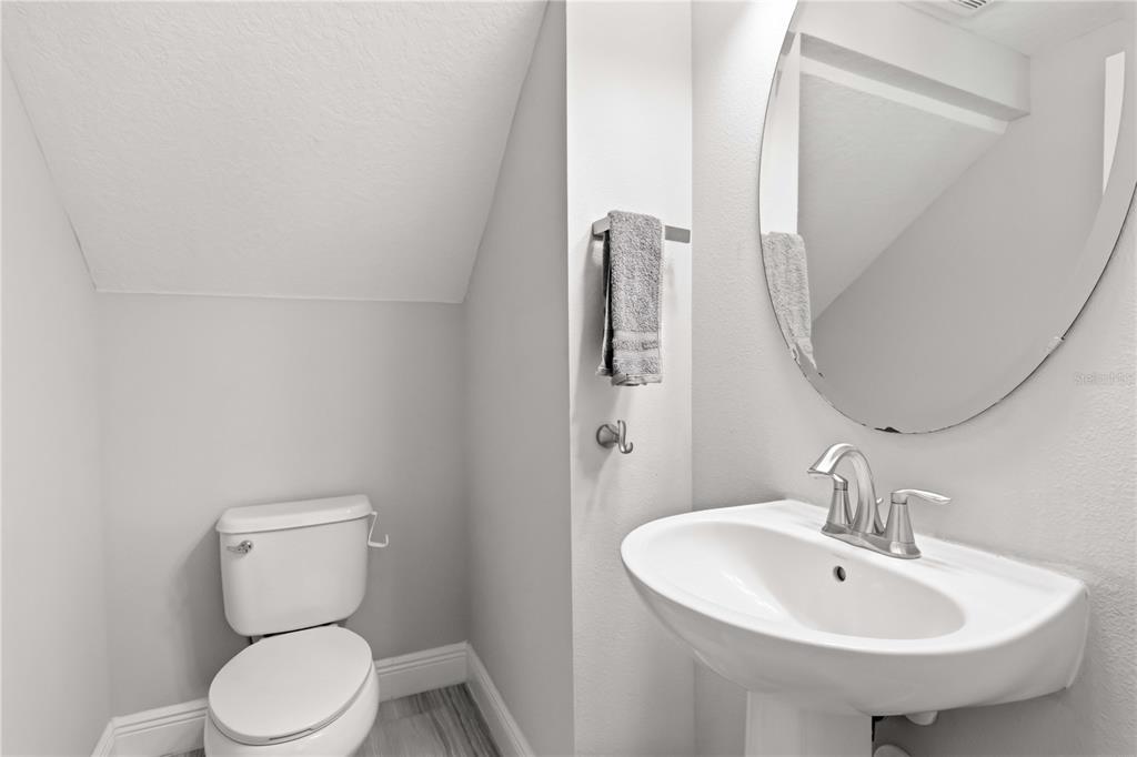 805 Viscount Street Brandon, FL 33511 - Photo 16 of 46 a bathroom with a toilet sink and mirror