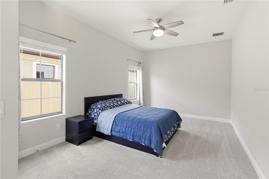 805 Viscount Street Brandon, FL 33511 - Photo 17 of 46 a bedroom with a bed chandelier and a window