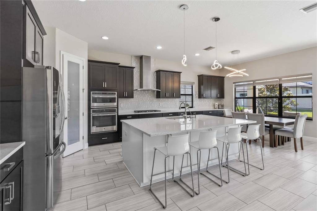 805 Viscount Street Brandon, FL 33511 - Photo 2 of 46 a kitchen with stainless steel appliances kitchen island granite countertop a refrigerator and a stove top oven