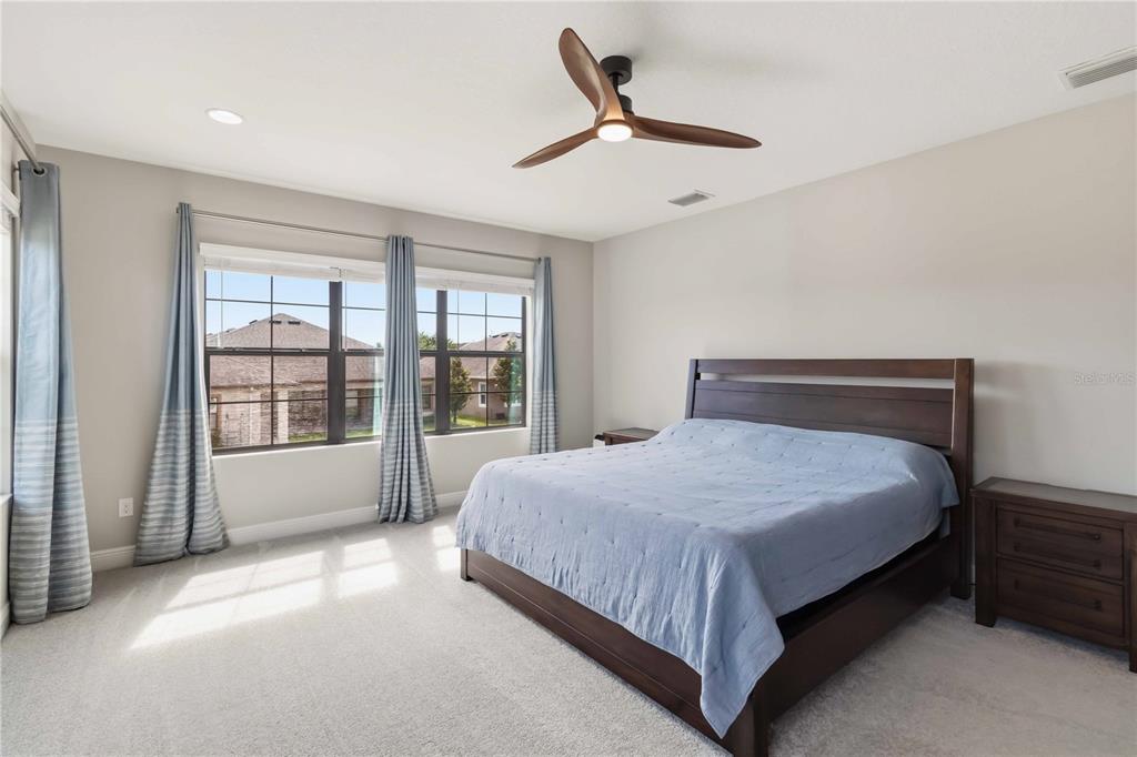 805 Viscount Street Brandon, FL 33511 - Photo 24 of 46 a large bed sitting in a room next to a window