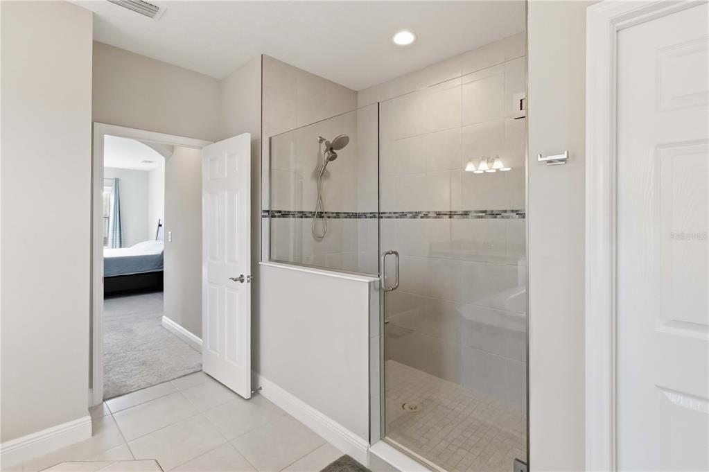 805 Viscount Street Brandon, FL 33511 - Photo 28 of 46 a bathroom with a glass shower door and a sink