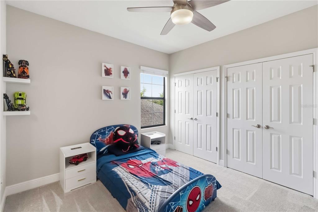 805 Viscount Street Brandon, FL 33511 - Photo 30 of 46 a bedroom with a bed and a chandelier