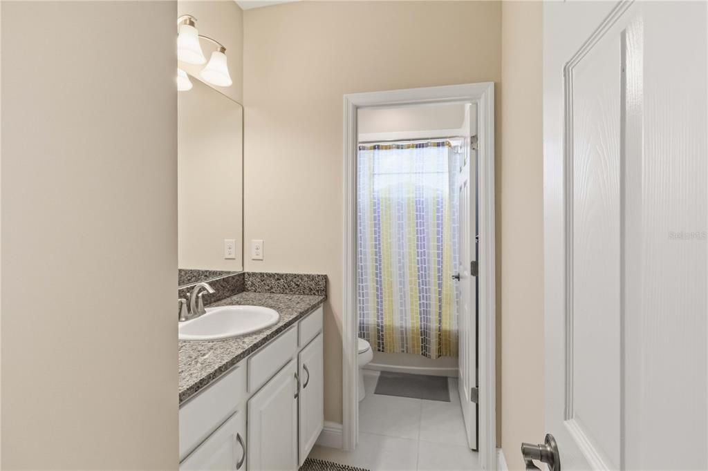 805 Viscount Street Brandon, FL 33511 - Photo 33 of 46 a bathroom with a granite countertop sink and a mirror