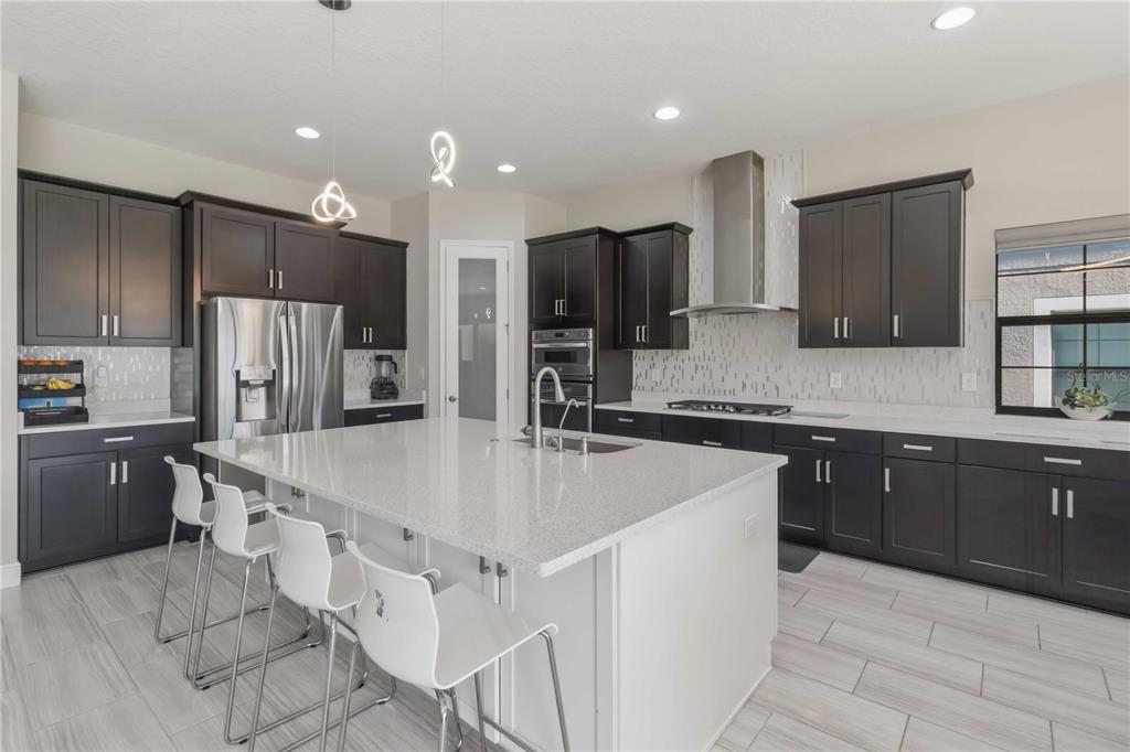 805 Viscount Street Brandon, FL 33511 - Photo 4 of 46 a large kitchen with kitchen island a sink stove and refrigerator