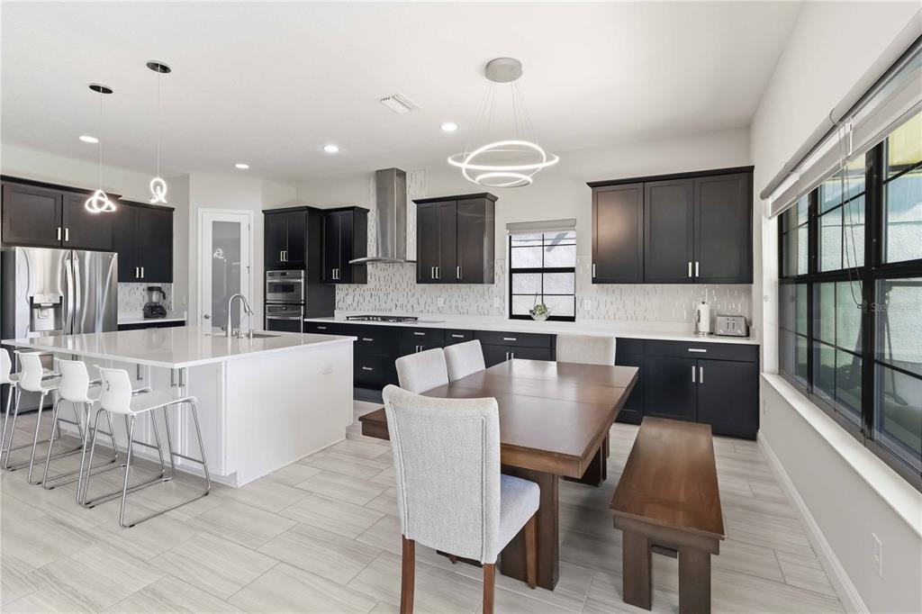 805 Viscount Street Brandon, FL 33511 - Photo 6 of 46 a large kitchen with kitchen island a large counter top space appliances and cabinets