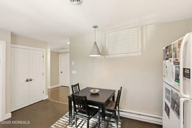 a view of a room with furniture and wooden floor