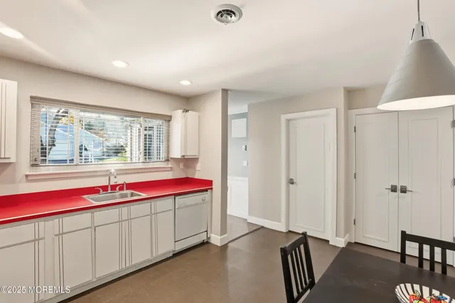 a bathroom with a granite countertop sink and mirror