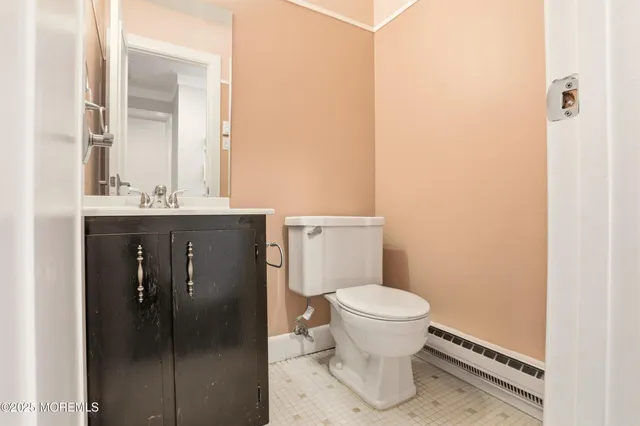 a bathroom with a granite countertop toilet and a sink