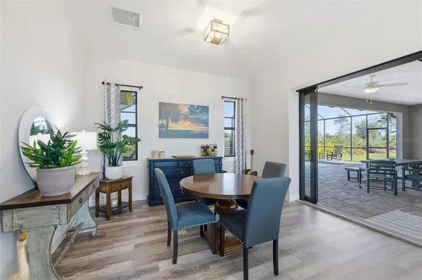 a kitchen with kitchen island a stove a table and chairs in it