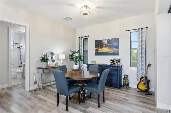 a large white kitchen with granite countertop a sink and a large window