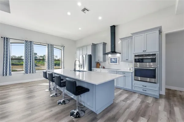 a kitchen with stainless steel appliances granite countertop a refrigerator and a sink