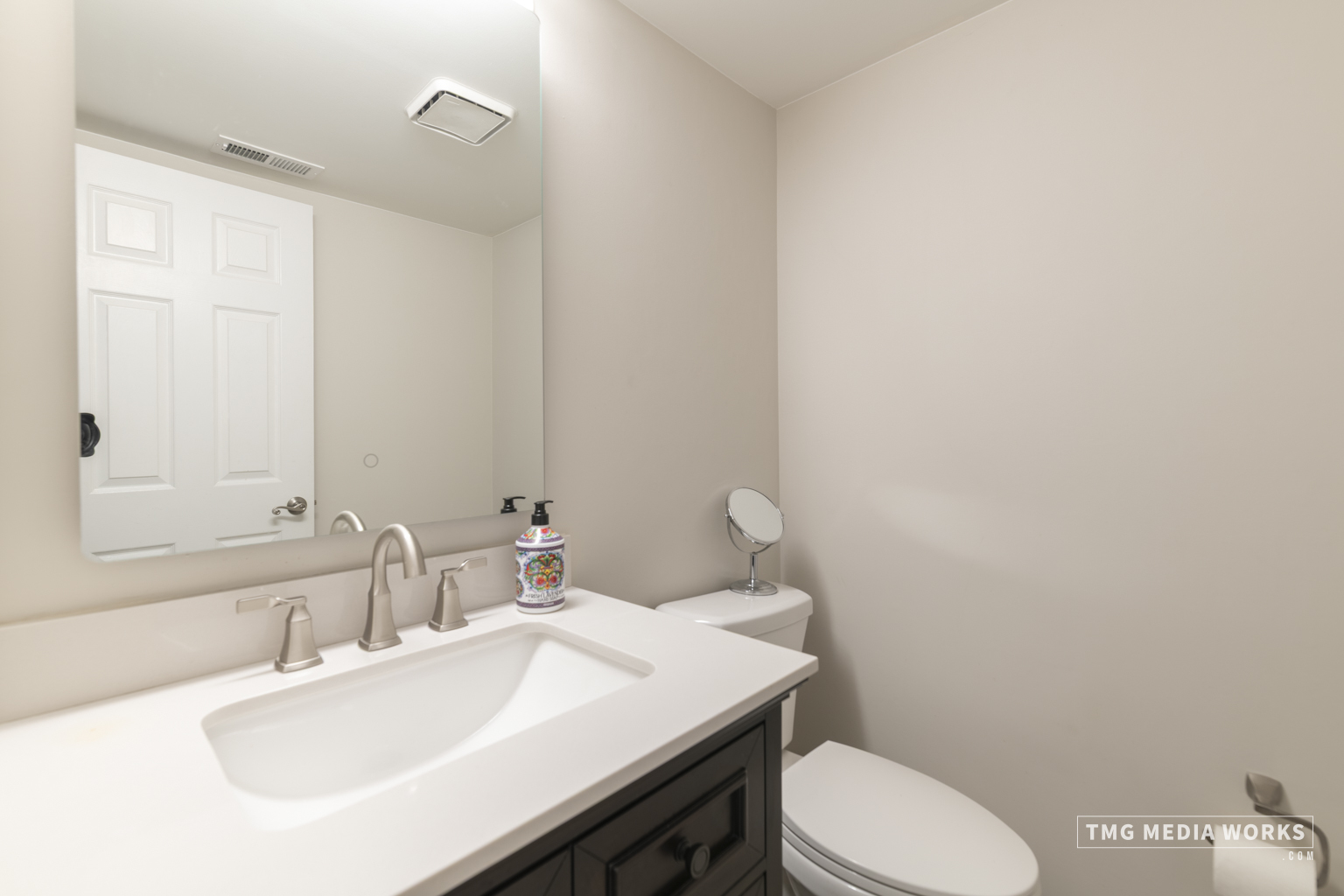 300 Churchill Lane Aurora, IL 60504 - Photo 18 of 30 a bathroom with a sink a toilet a mirror and vanity