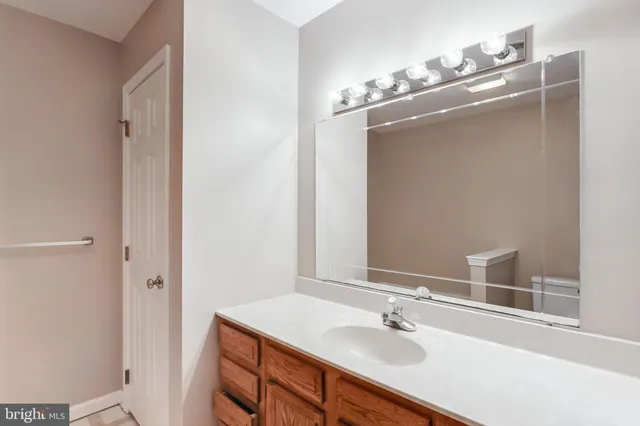 a bathroom with a sink vanity and a mirror
