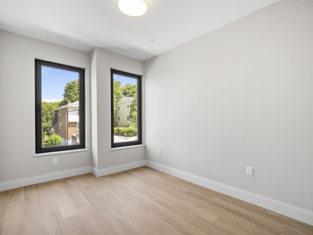 249 Corey Road, Unit 105 Boston, MA 02135 - Photo 12 of 39 an empty room with windows