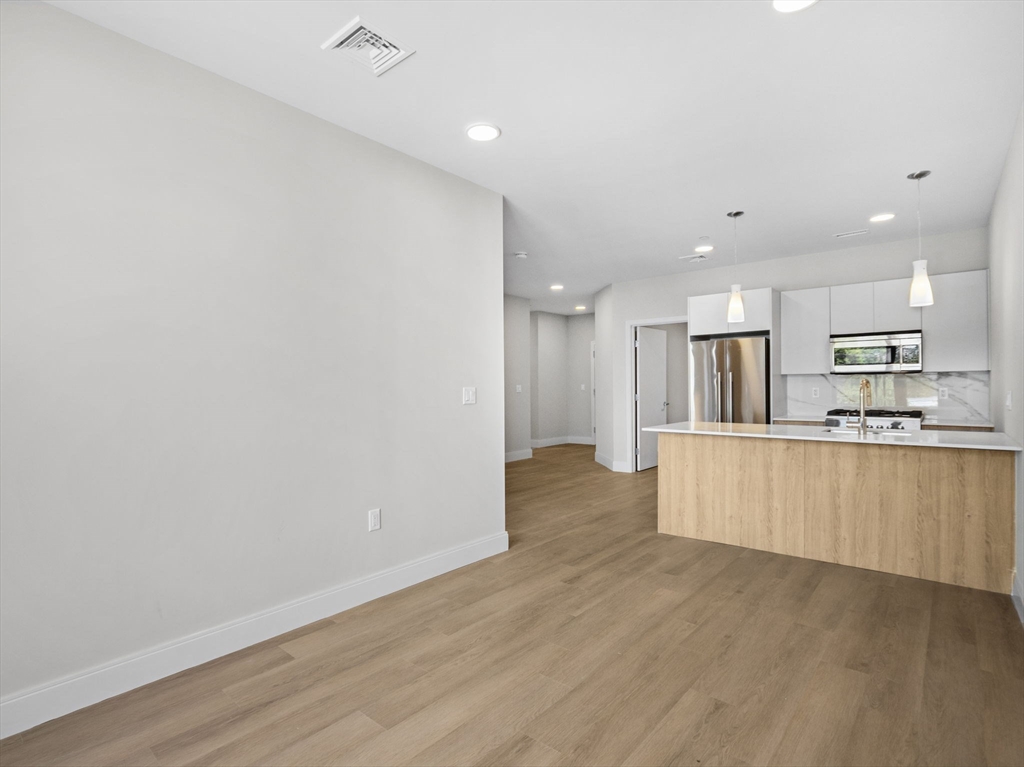 249 Corey Road, Unit 105 Boston, MA 02135 - Photo 17 of 39 a view of kitchen with wooden floor