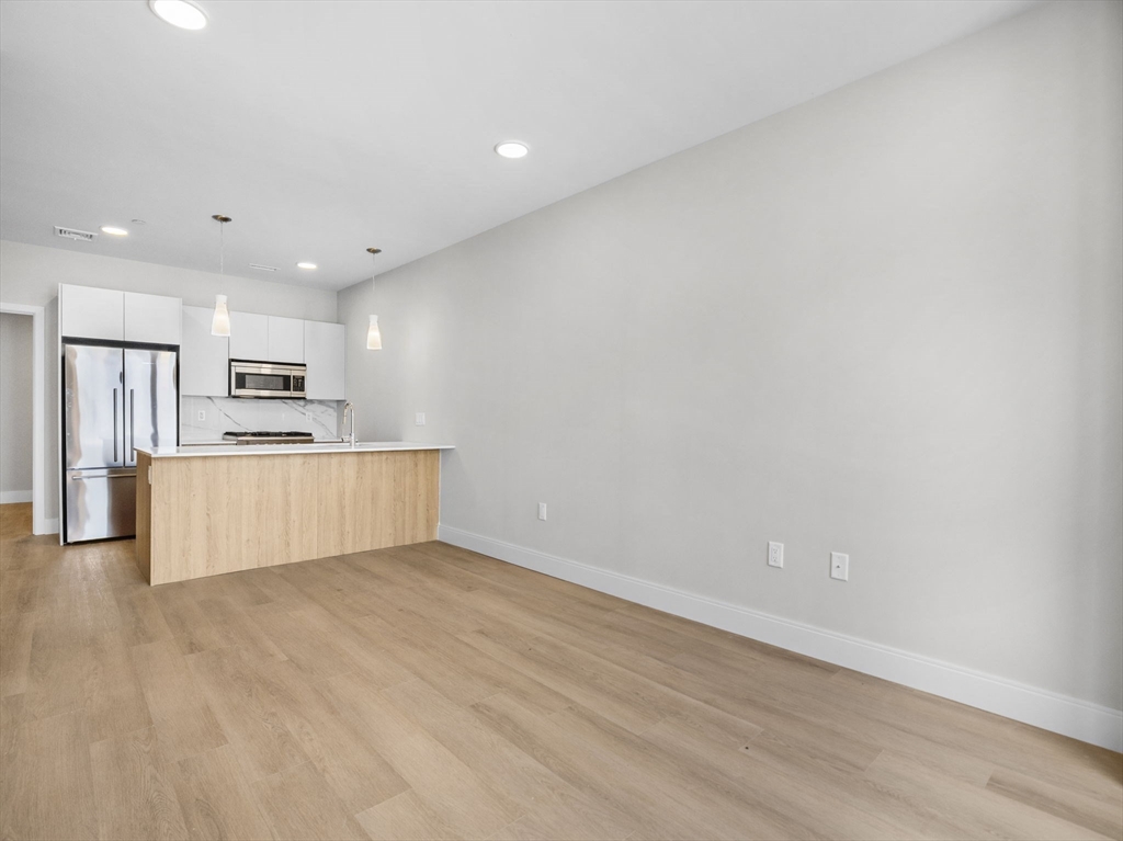 249 Corey Road, Unit 105 Boston, MA 02135 - Photo 18 of 39 a view of kitchen with wooden floor