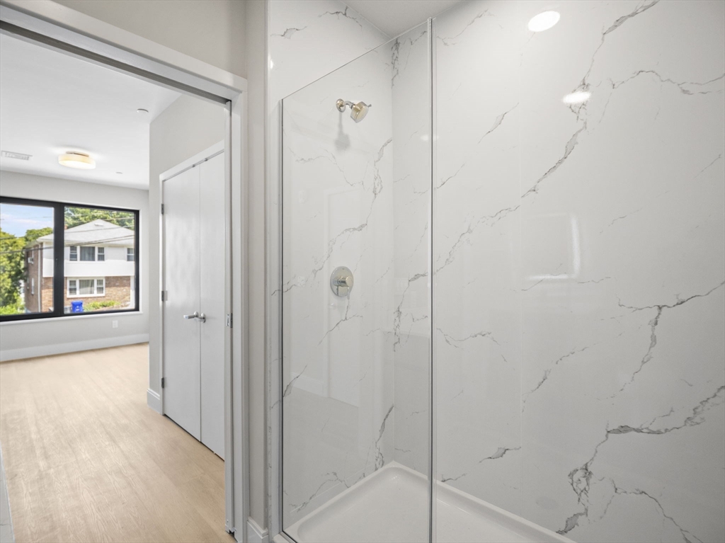 249 Corey Road, Unit 105 Boston, MA 02135 - Photo 21 of 39 a bathroom with a shower
