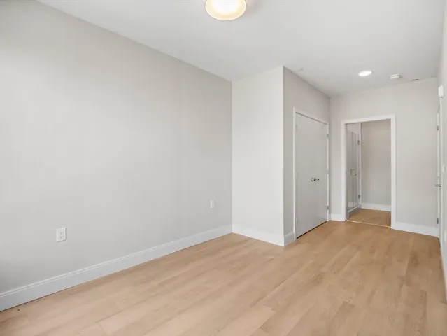a view of hallway with wooden floor