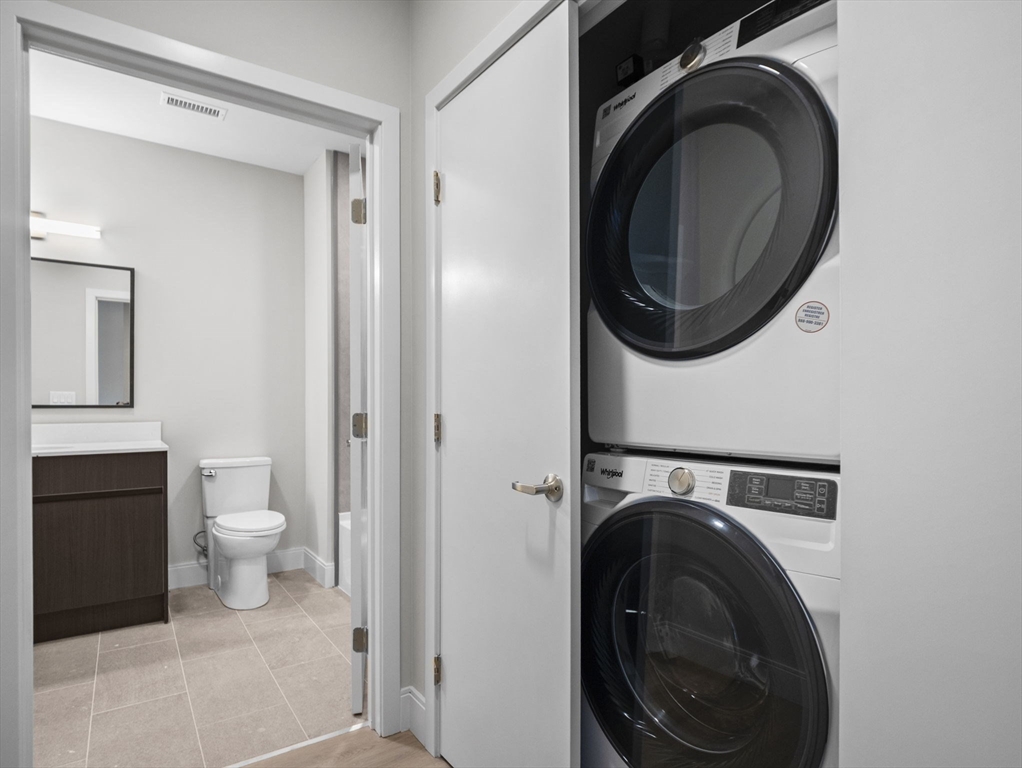 249 Corey Road, Unit 105 Boston, MA 02135 - Photo 27 of 39 a view of a hallway with washer and dryer
