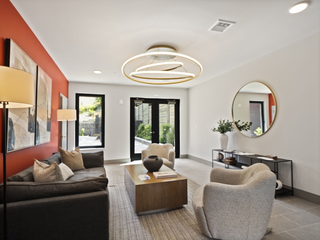 249 Corey Road, Unit 105 Boston, MA 02135 - Photo 30 of 39 a living room with furniture and a large window