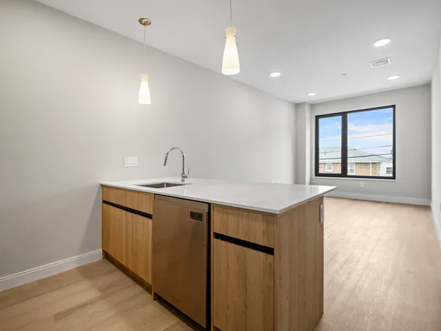 a view of a kitchen with sink and dishwasher