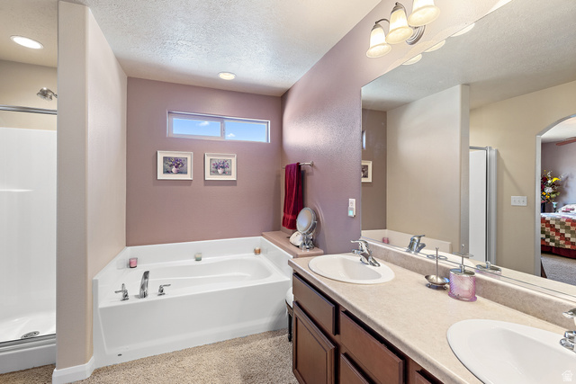 2484 Manzoni Road Santa Clara, UT 84765 - Photo 20 of 27 Bathroom with a shower stall, ensuite bathroom, double vanity, a textured ceiling, and a garden tub